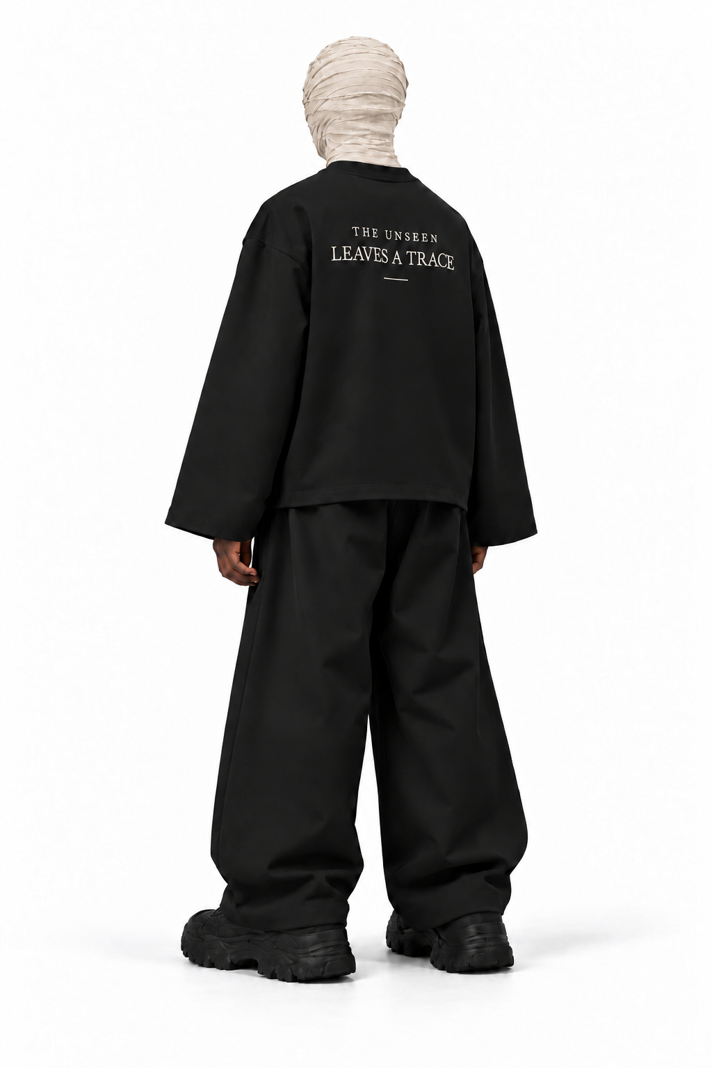 The Unseen black long sleeve — male model, back, transparent background