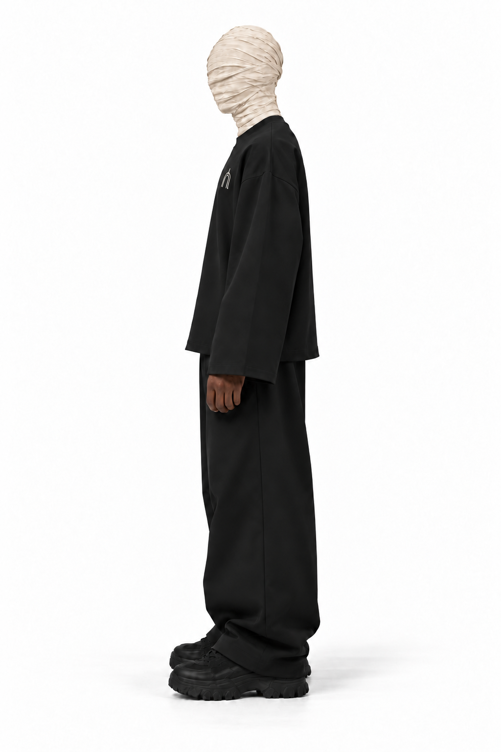 The Unseen black long sleeve — male model, side, transparent background
